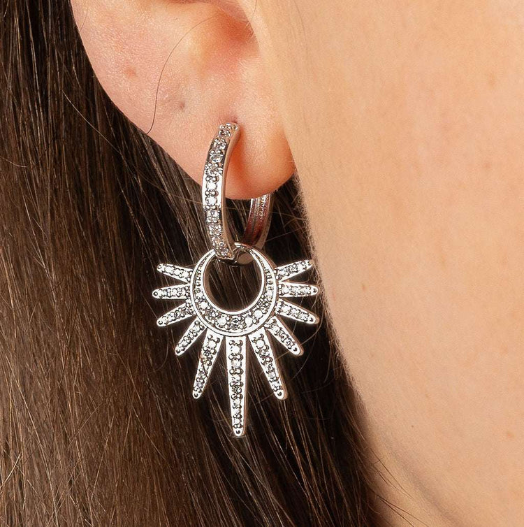 Shimmering Crescent Hoops with cubic zirconia starburst design on ear.